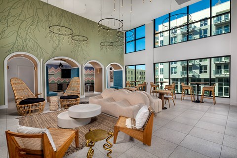 A living room with a large couch and a green wallpaper.