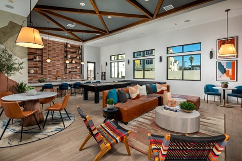 a living room with couches and tables and chairs