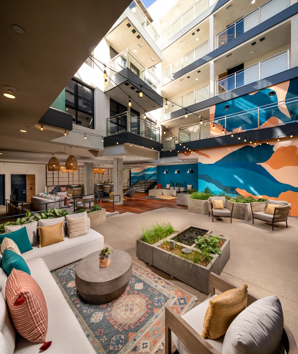 the lobby of a building with couches and a rug