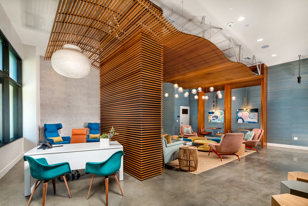 a living room with a table and chairs and a wooden structure