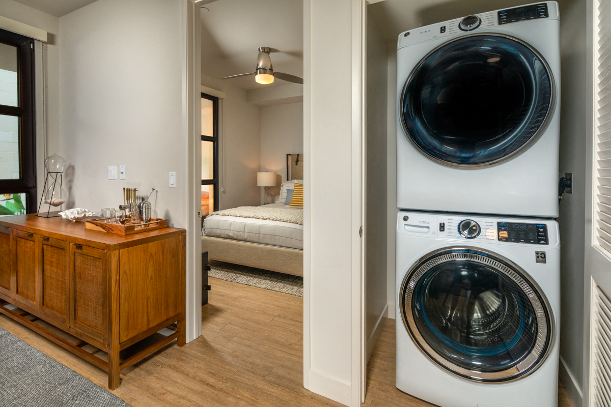 a washer and dryer in a room next to a bedroom