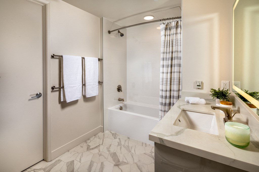 a bathroom with a tub and a sink and a shower