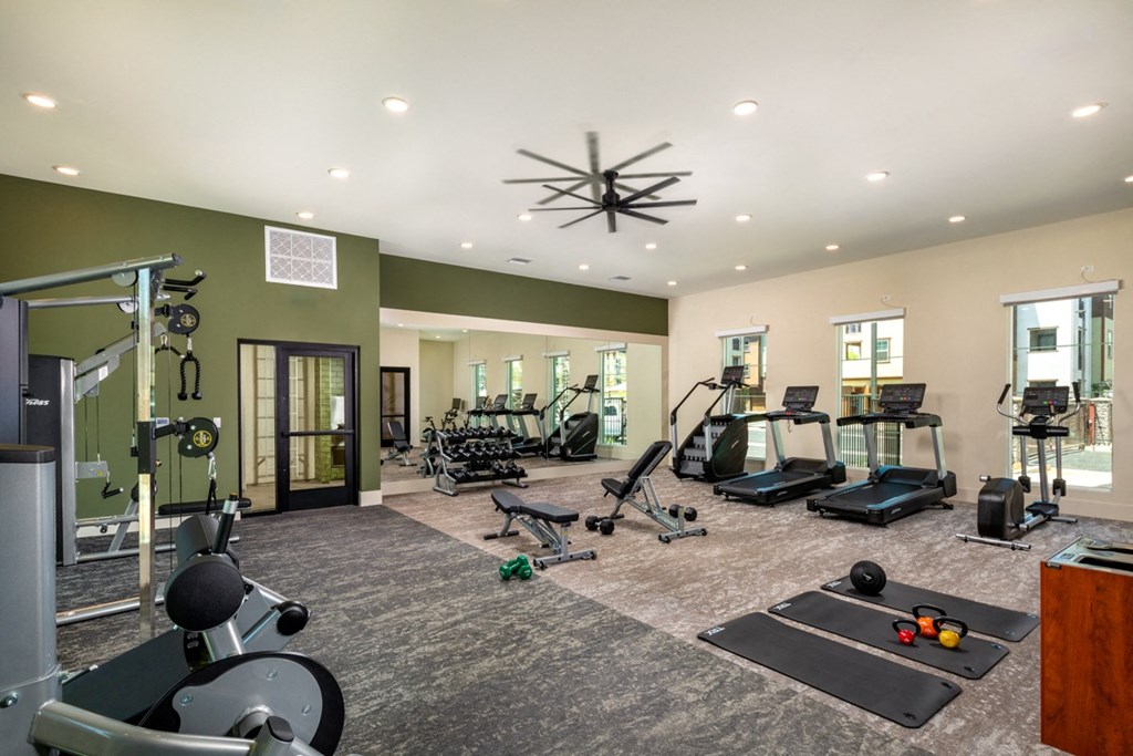 a home gym with exercise equipment and a chandelier