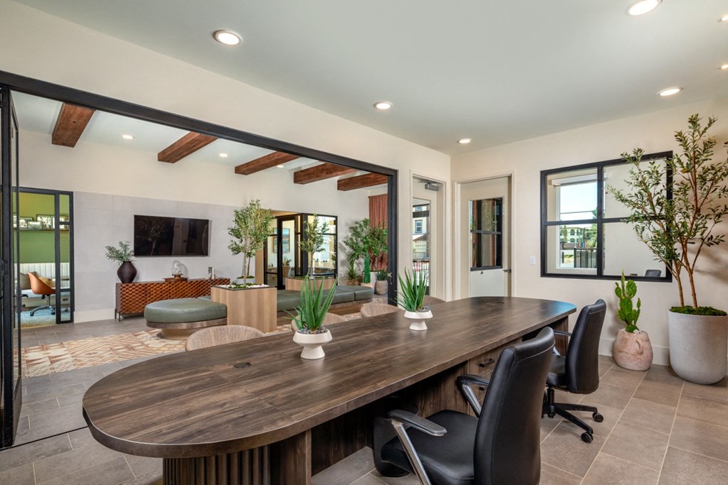 a large dining room with a wooden table and chairs