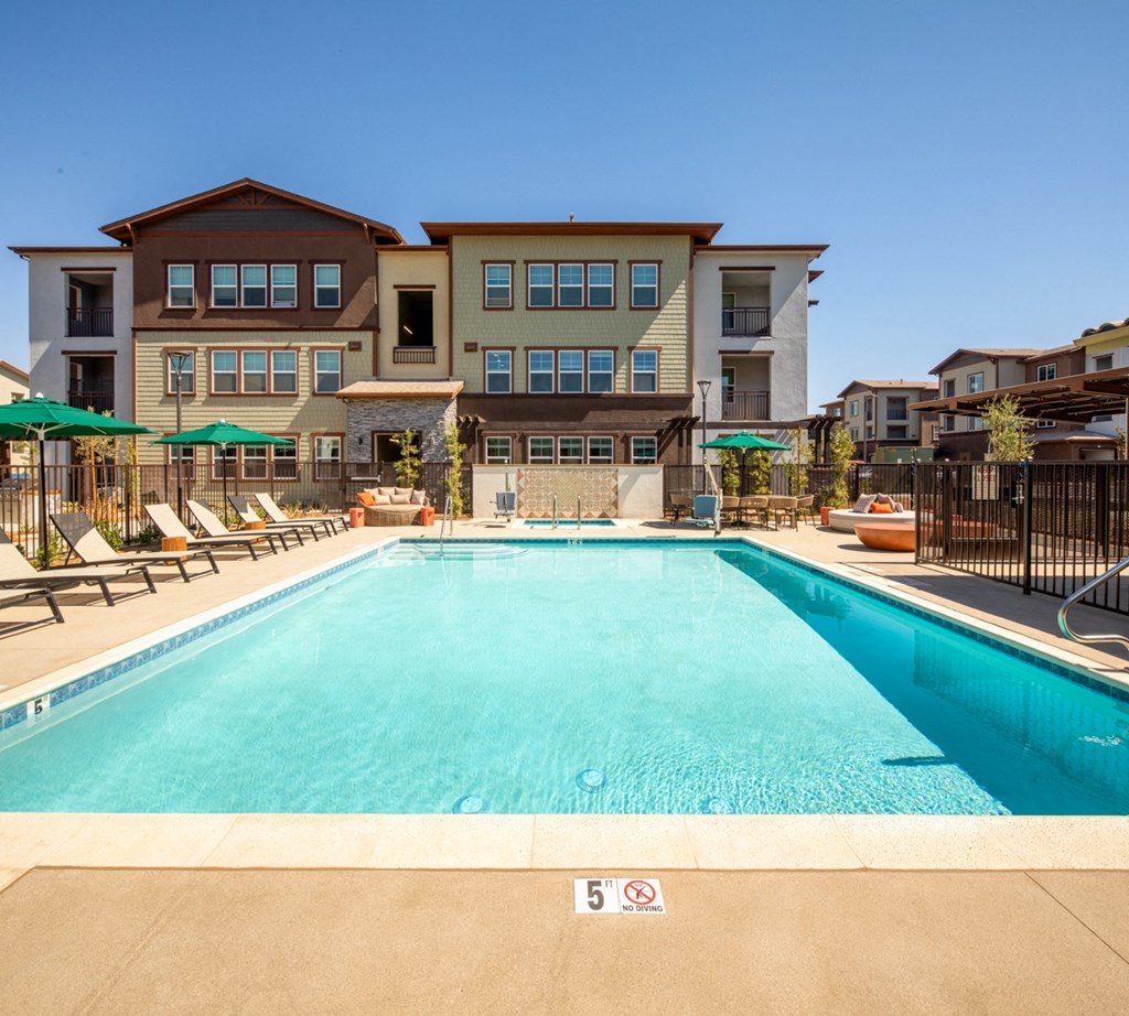 a swimming pool with a building in the background