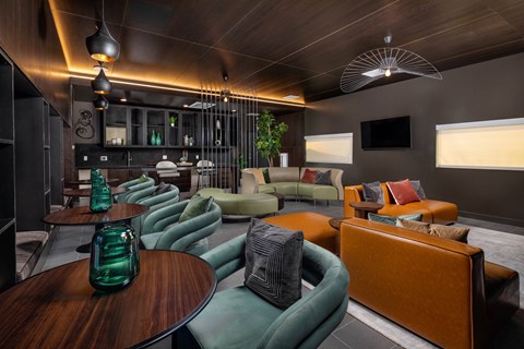 A room with a green couch and a brown table.