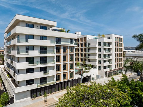 A modern multi-story residential building with balconies and windows.