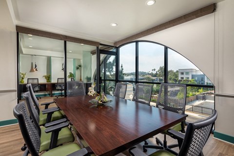 A conference room with a long table and chairs.