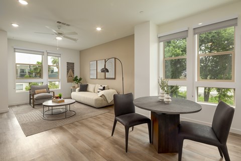 A modern living room with a round table and chairs.