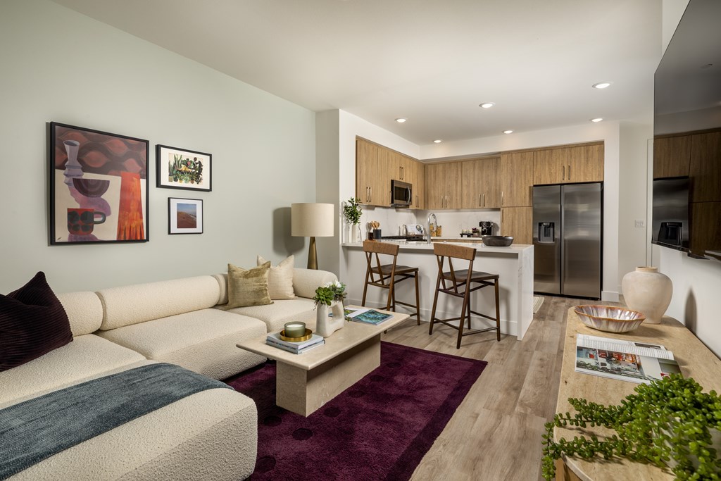 A modern living room with a white sofa and a coffee table.