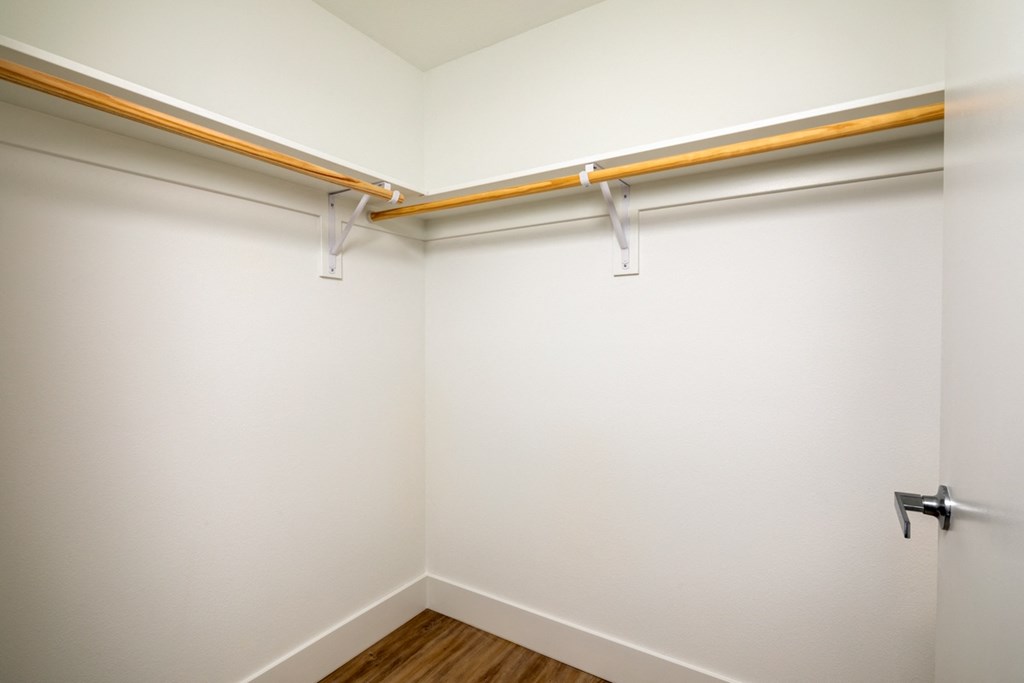 an empty room with a white wall and a sliding closet door