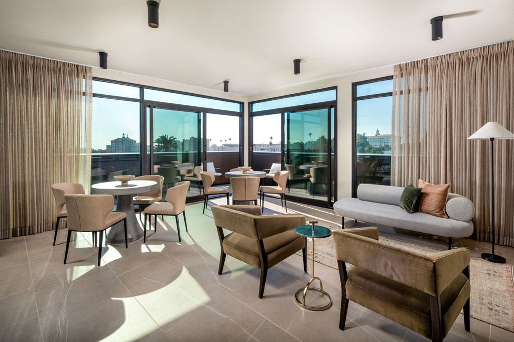 a living room with couches and chairs and a balcony