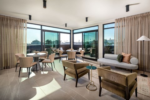 a living room with couches and chairs and a balcony