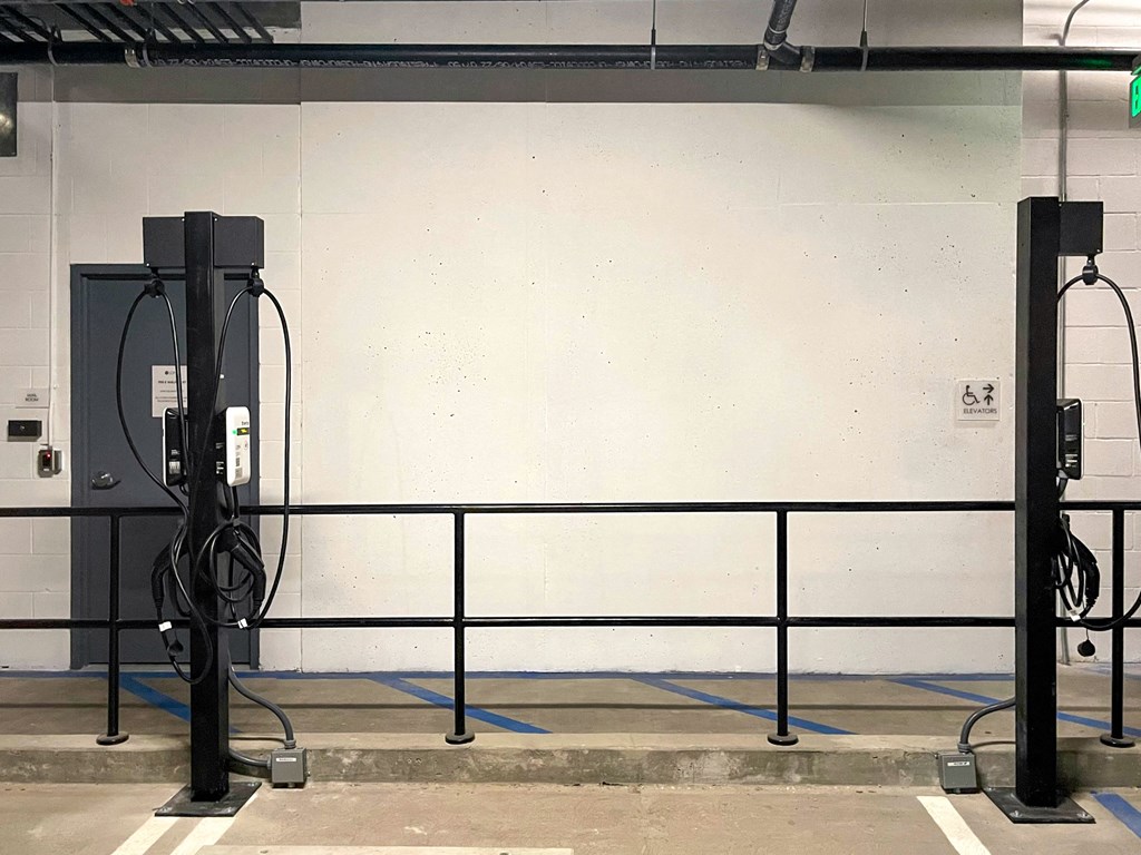 the wall of a parking garage with a lot of gas pumps