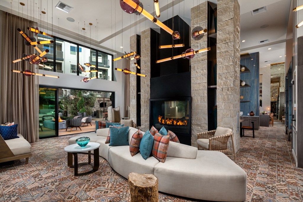 a living room with a large white couch and a fireplace