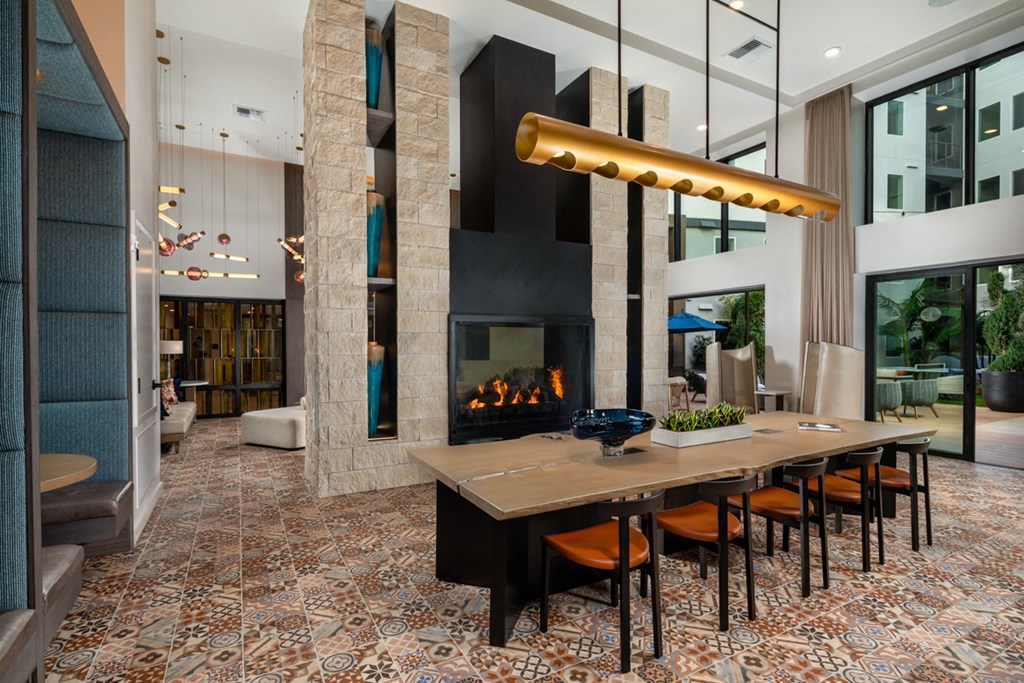 a dining room with a table and chairs in front of a fireplace