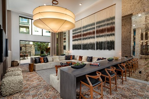 a large living room with a long table and chairs