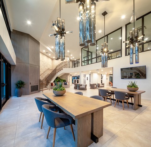 a dining room with a wooden table and blue chairs