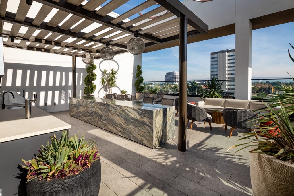 a covered patio with a bar and a view of the city