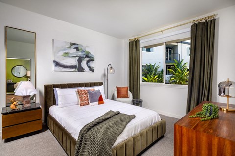a bedroom with a bed and a window