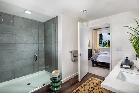a bathroom with a glass shower stall and a sink