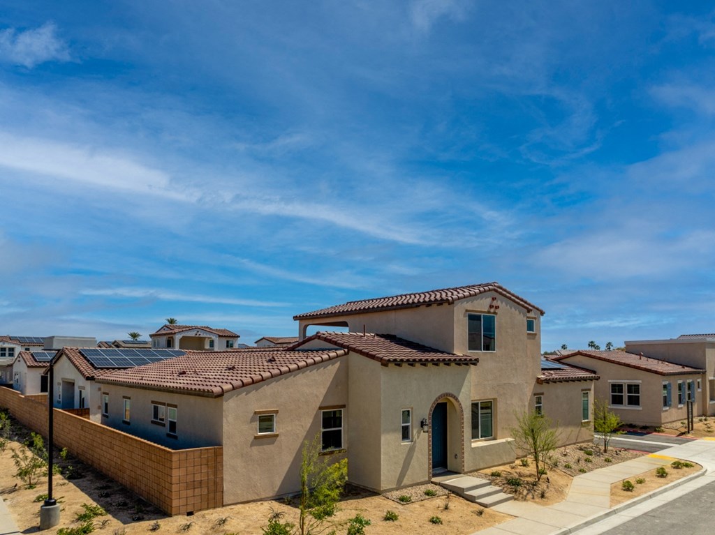 an aerial view of a group of houses with solar panels on the roof