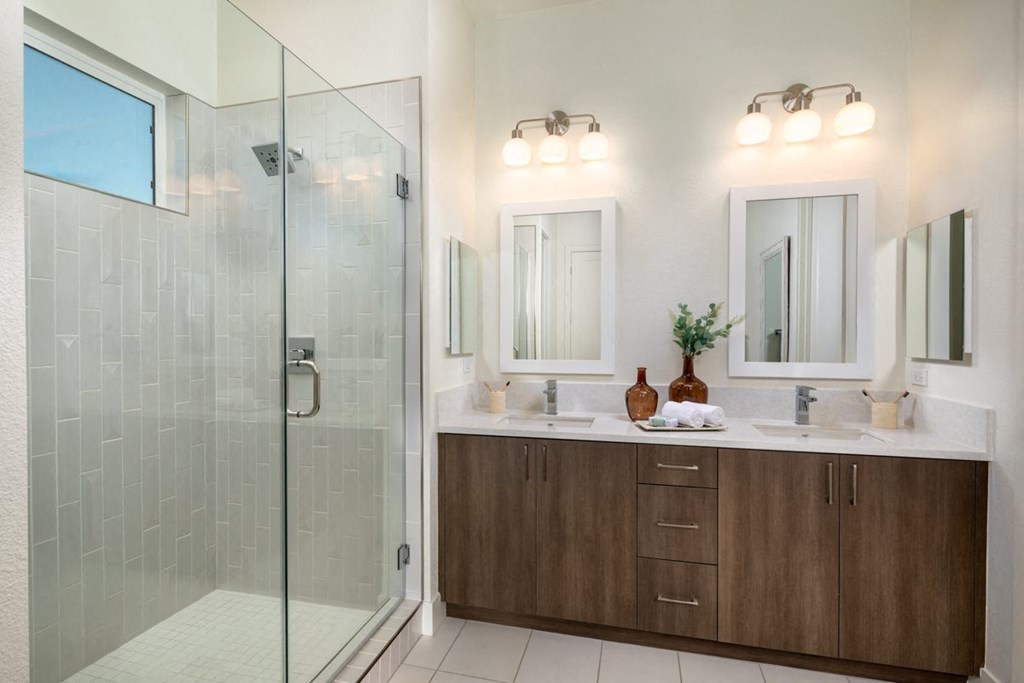 a bathroom with a shower and two sinks