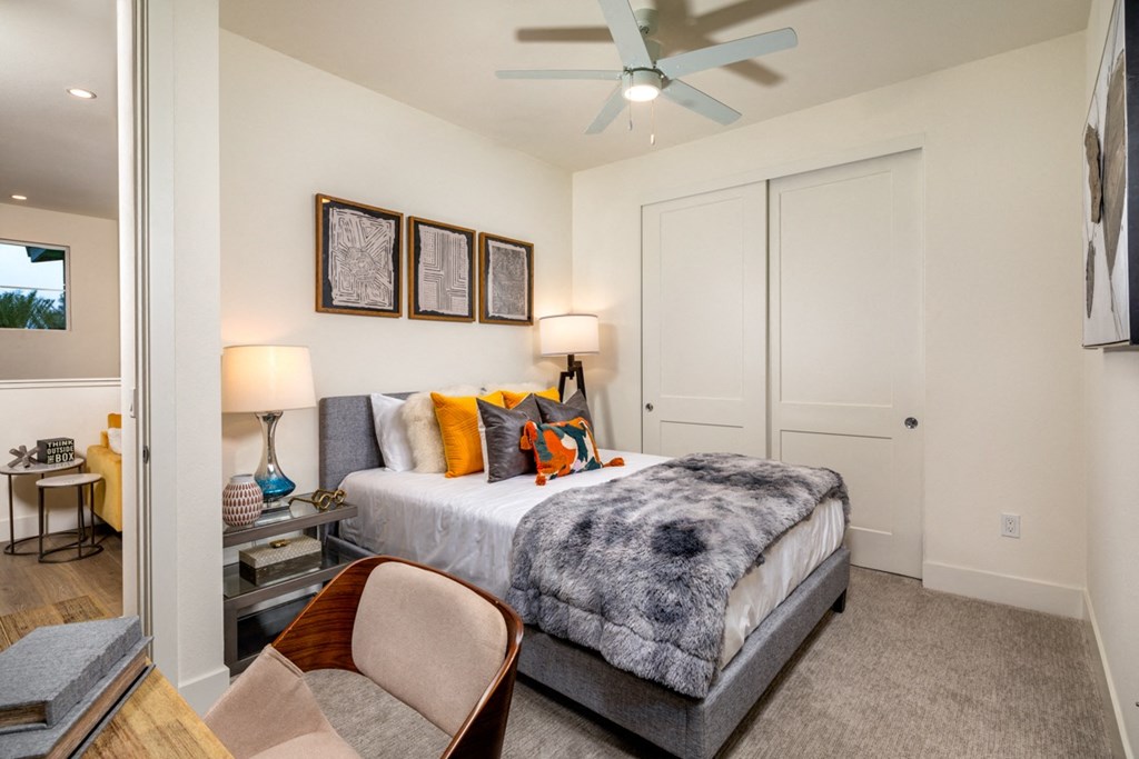 a bedroom with a bed and a ceiling fan