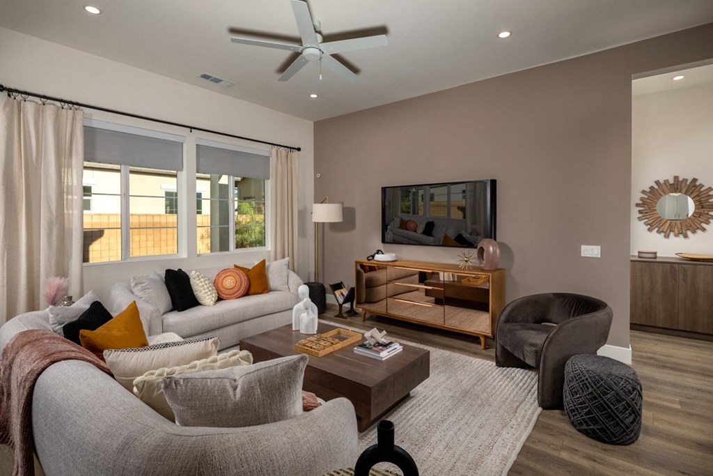 a living room with a couch and a chair and a tv