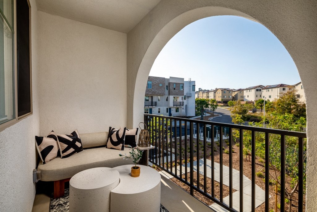 a balcony with a couch and a table