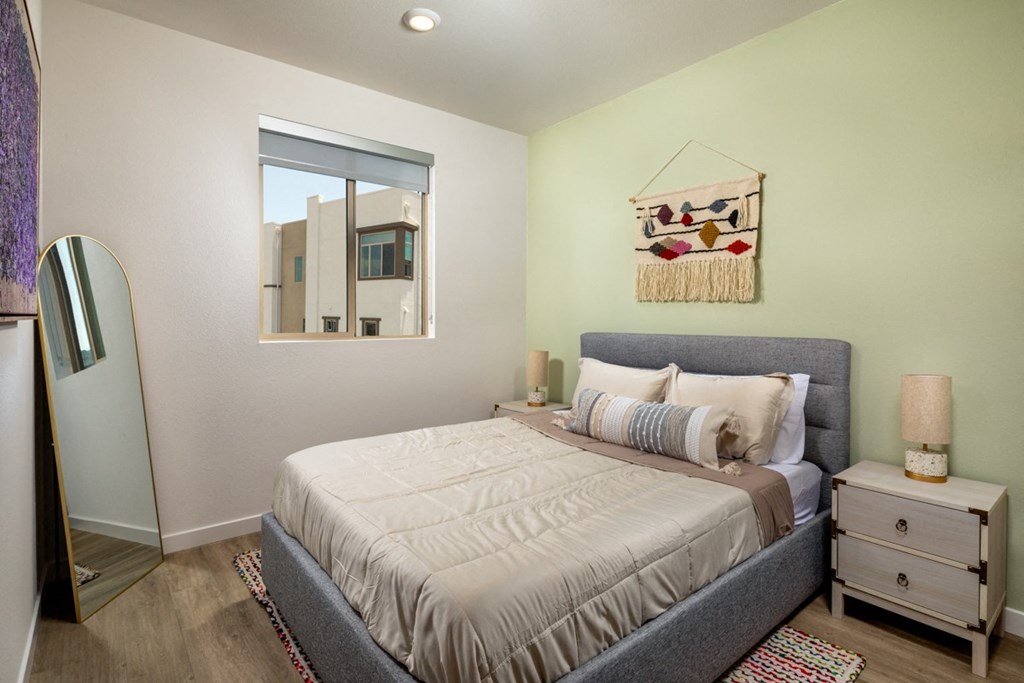 a bedroom with a large bed and a mirror