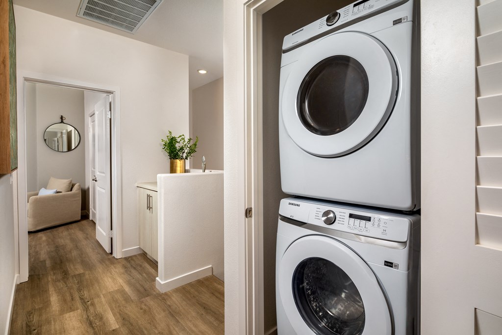 a front loading washer and dryer in a laundry room