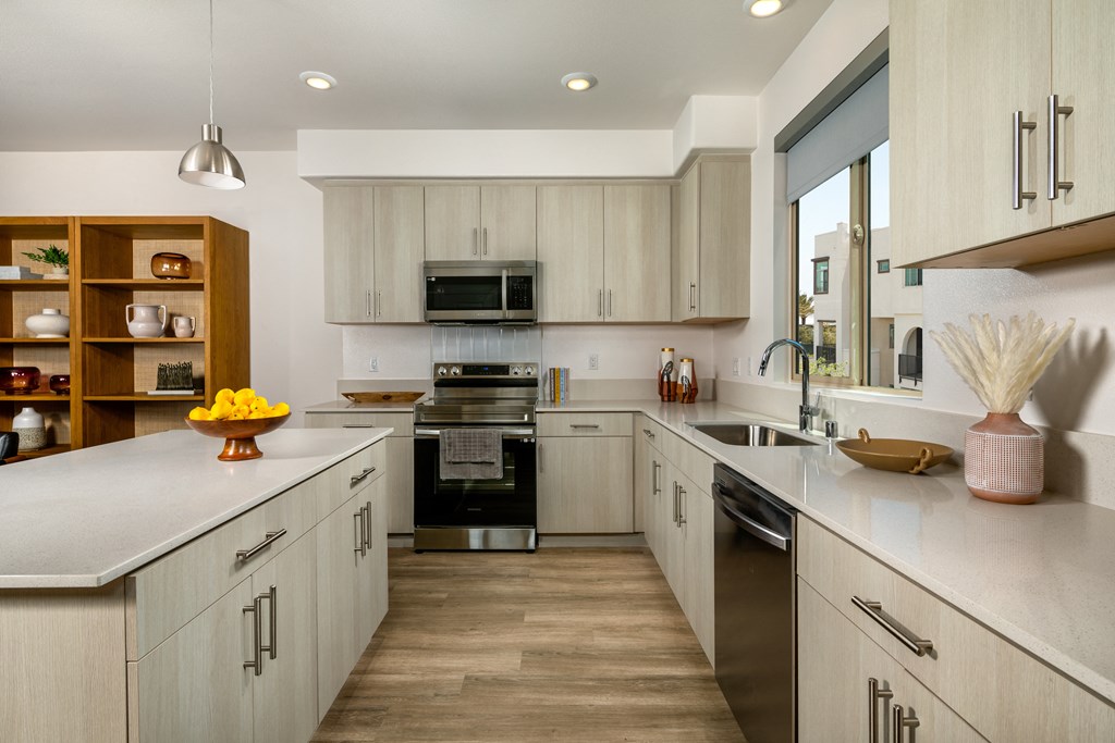 a kitchen with white cabinets and a large counter top
