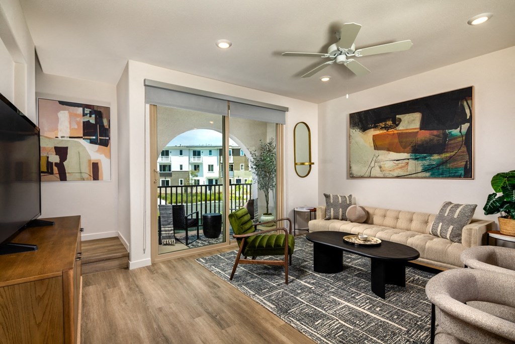 an open living room with a sliding glass door to a balcony