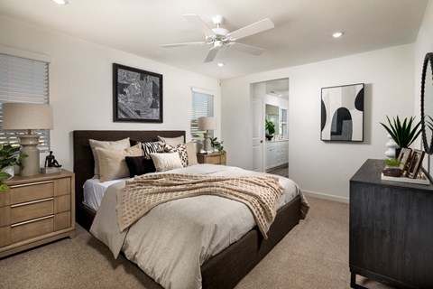 a bedroom with a bed and a ceiling fan