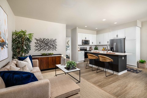 A modern living room with a beige couch and a coffee table.