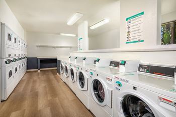 A row of washing machines in a laundromat.