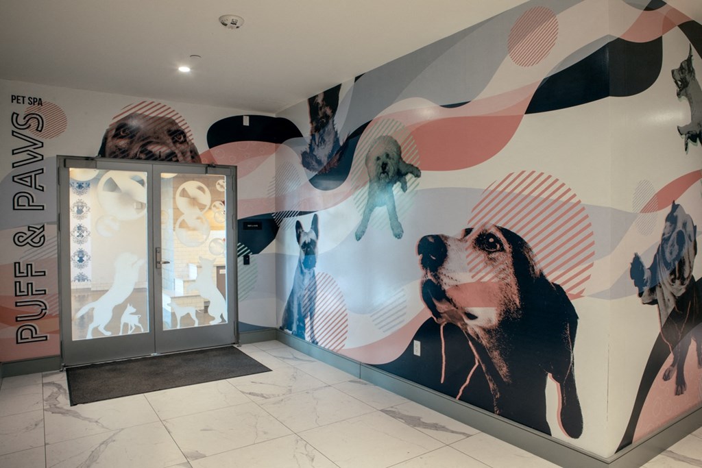 a large mural of dogs and people is on the side of a building