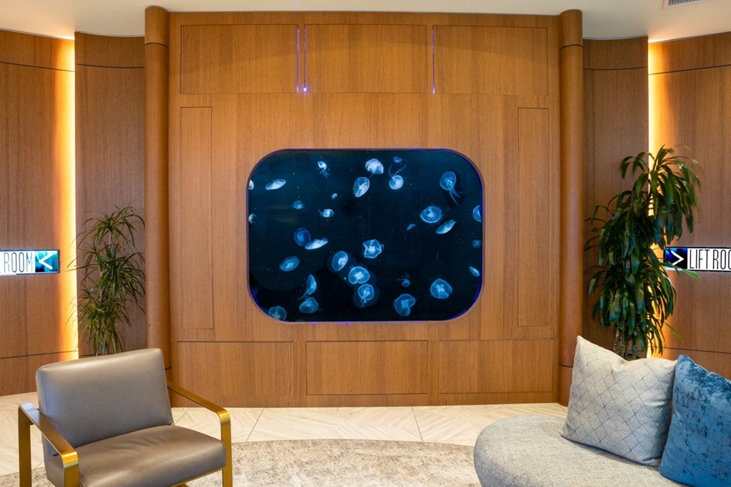 a painting in a wood paneled room with a couch and chair