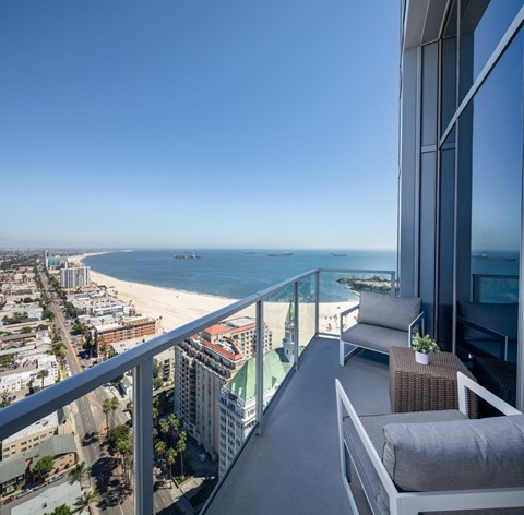 a balcony with a view of the ocean and a city