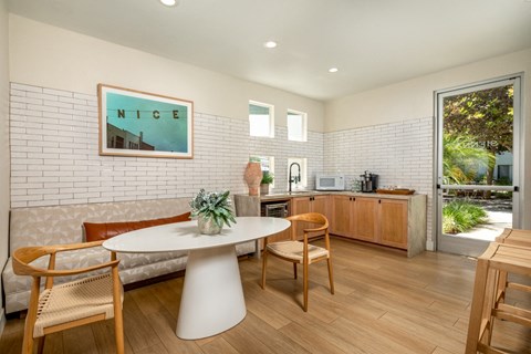 A dining area with a white table and chairs.