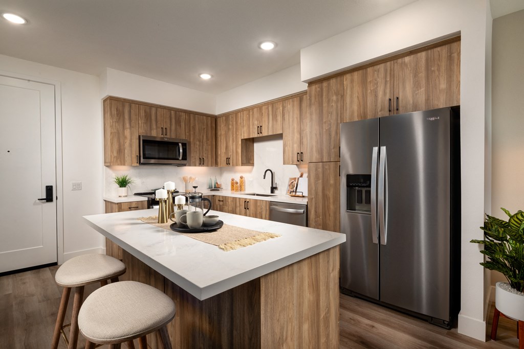 a kitchen with stainless steel appliances and a marble counter top