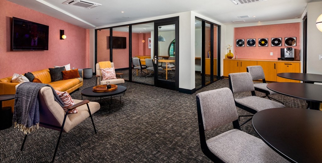 a living room with couches and chairs and a table and a television