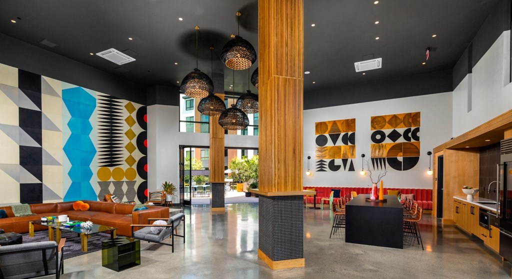 the lobby of a hotel with couches tables and chairs and a reception desk