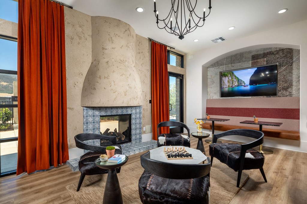 a living room filled with furniture and a large fireplace