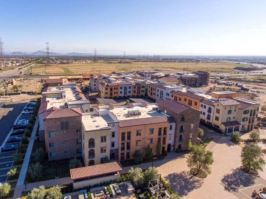 an aerial view of a city with buildings and the desert in the background