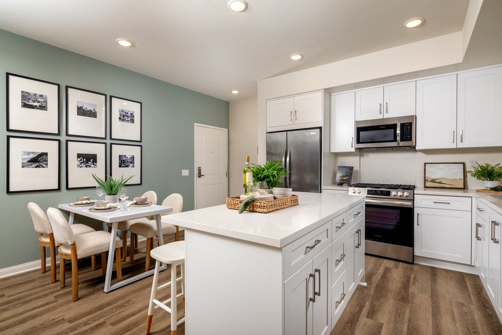 an open kitchen and dining area with a table and chairs