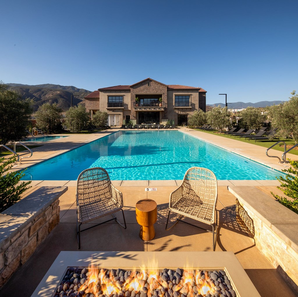 a swimming pool with a house in the background