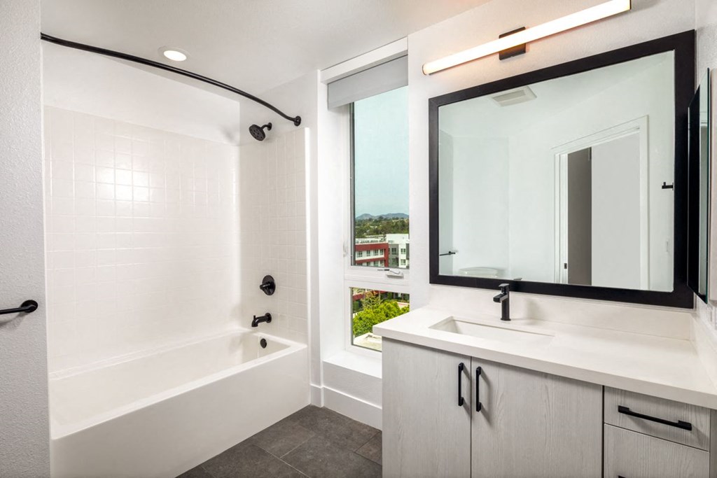 a bathroom with a bathtub and a sink at VORA LUX, San Diego, CA