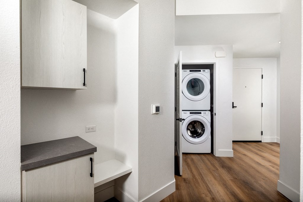 a washer and dryer in a small apartment at VORA LUX, San Diego, CA 92120